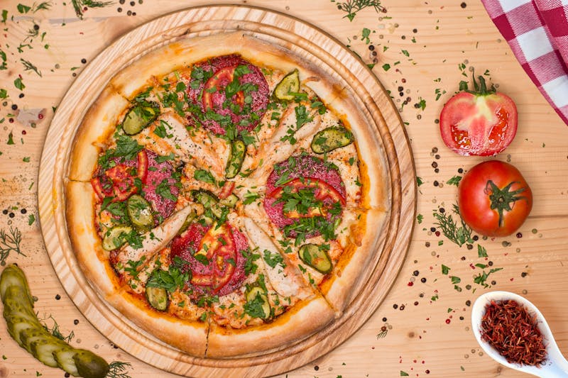 Perfectly charred wood-fired pizza slice ready to serve